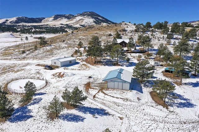 snowy aerial view with a mountain view