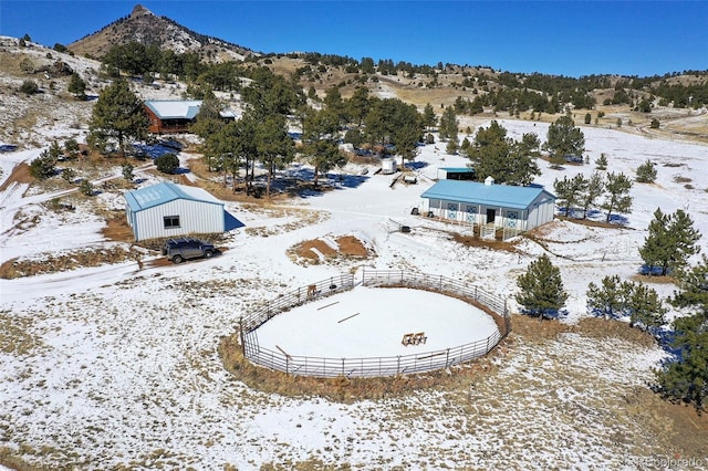 snowy aerial view featuring a mountain view