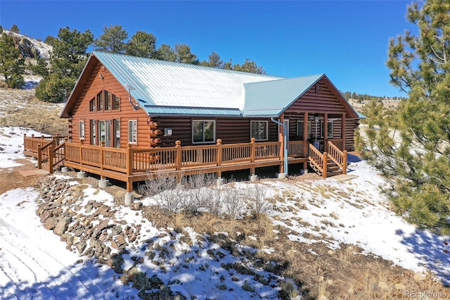 view of front of property with log siding and metal roof