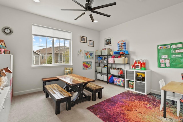 rec room with ceiling fan and light carpet