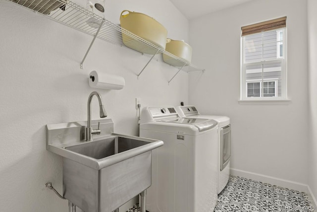 laundry room with separate washer and dryer, sink, and light tile patterned floors