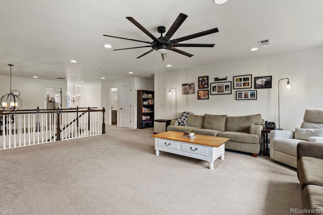 living room with light colored carpet and a notable chandelier