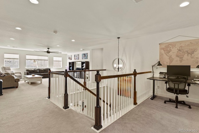 interior space with ceiling fan with notable chandelier