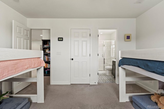 bedroom with light carpet and connected bathroom