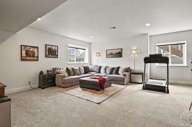 living room featuring light carpet and a textured ceiling