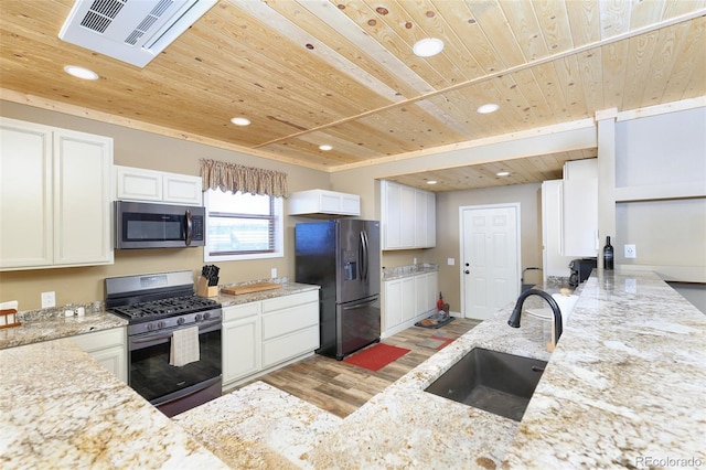 kitchen with light stone counters, stainless steel appliances, visible vents, wood ceiling, and a sink