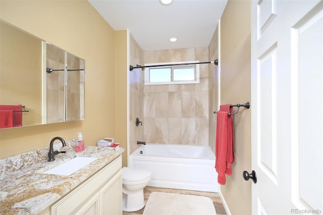 bathroom with recessed lighting, shower / bathing tub combination, vanity, and toilet