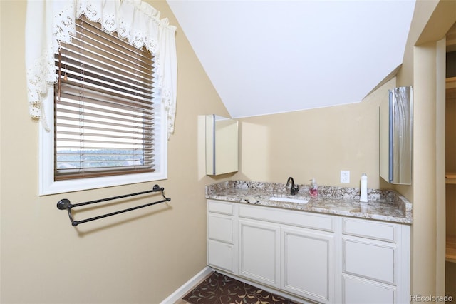 bathroom with vanity and baseboards