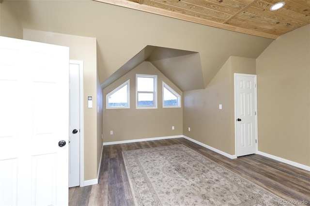 additional living space with lofted ceiling, dark wood-style floors, wood ceiling, and baseboards