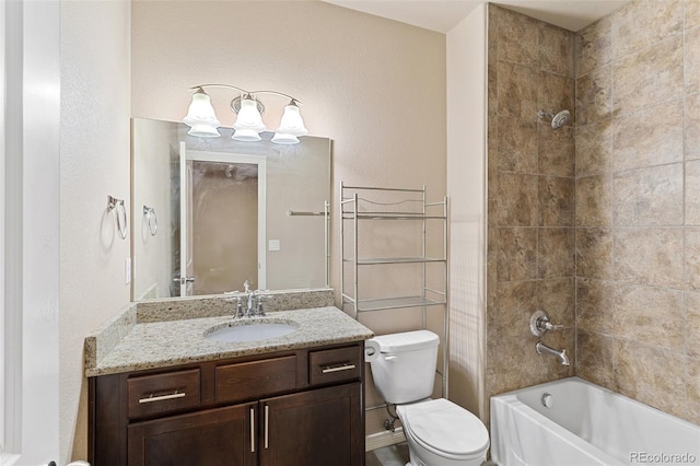 full bathroom with toilet, vanity, and tiled shower / bath