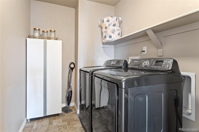 clothes washing area featuring independent washer and dryer