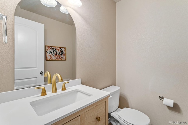 bathroom featuring toilet and vanity