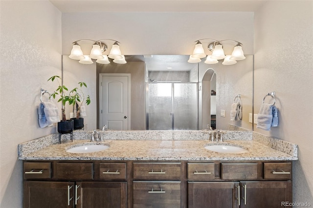 bathroom with walk in shower and vanity