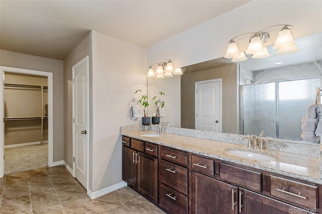 bathroom with a shower with shower door and vanity