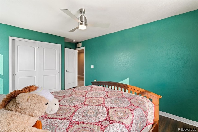 bedroom with ceiling fan, dark hardwood / wood-style floors, and a closet