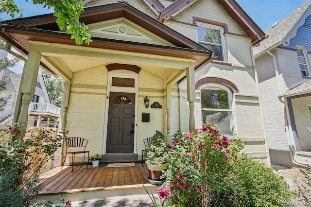 351 Bannock St, Denver, CO 80223 - view of exterior entry featuring covered porch and brick siding