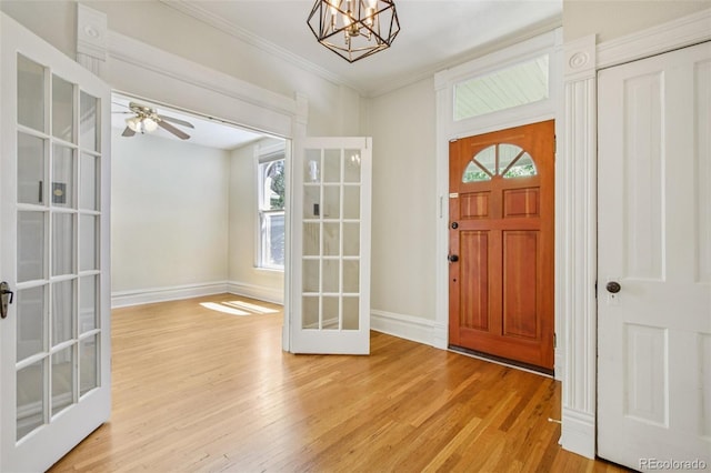 351 Bannock St, Denver, CO 80223 - entrance foyer with french doors, light wood finished floors, a chandelier, ornamental molding, and ceiling fan