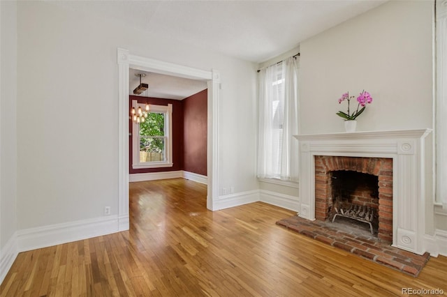 351 Bannock St, Denver, CO 80223 - unfurnished living room with wood-type flooring, a chandelier, and a fireplace