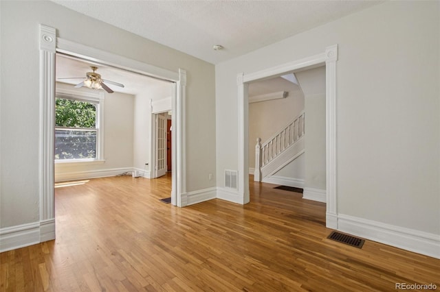 351 Bannock St, Denver, CO 80223 - spare room featuring wood finished floors, stairs, ceiling fan, and a smoke detector