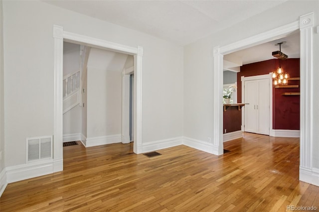 351 Bannock St, Denver, CO 80223 - unfurnished room featuring a chandelier and light wood-style flooring