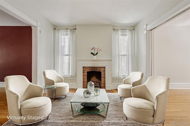 351 Bannock St, Denver, CO 80223 - living area featuring wood finished floors, plenty of natural light, a fireplace, and a textured ceiling