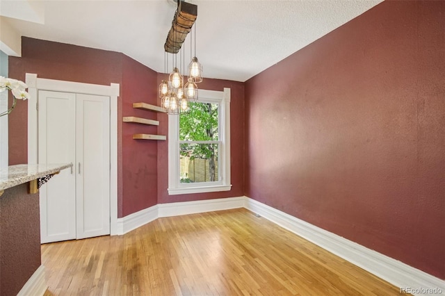351 Bannock St, Denver, CO 80223 - unfurnished dining area featuring a chandelier and light wood finished floors