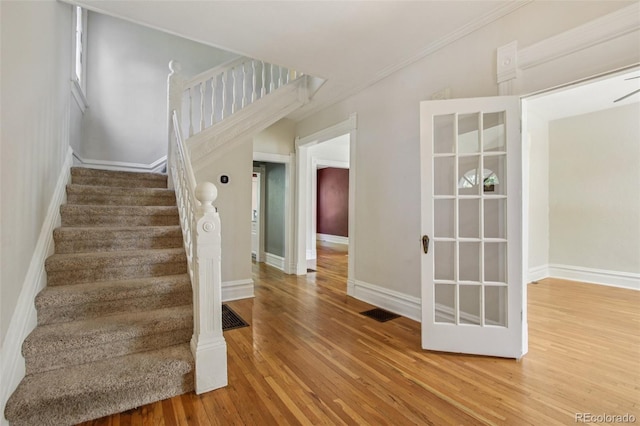 351 Bannock St, Denver, CO 80223 - stairs with wood finished floors and crown molding