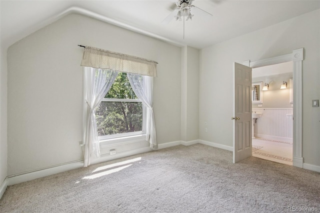 351 Bannock St, Denver, CO 80223 - unfurnished bedroom featuring carpet floors, vaulted ceiling, connected bathroom, and a ceiling fan