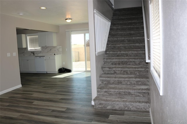 stairway with hardwood / wood-style flooring and sink