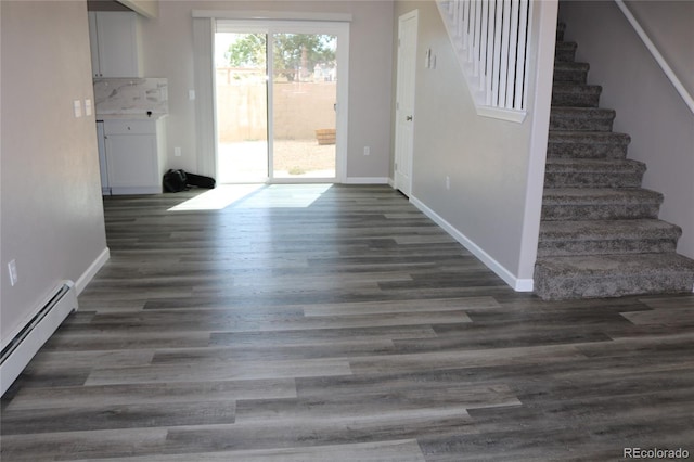 interior space featuring baseboard heating and dark hardwood / wood-style floors