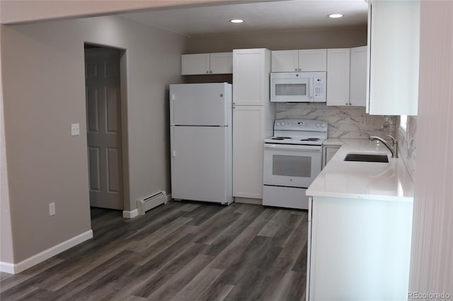 kitchen featuring dark wood-type flooring, white cabinets, white appliances, baseboard heating, and sink