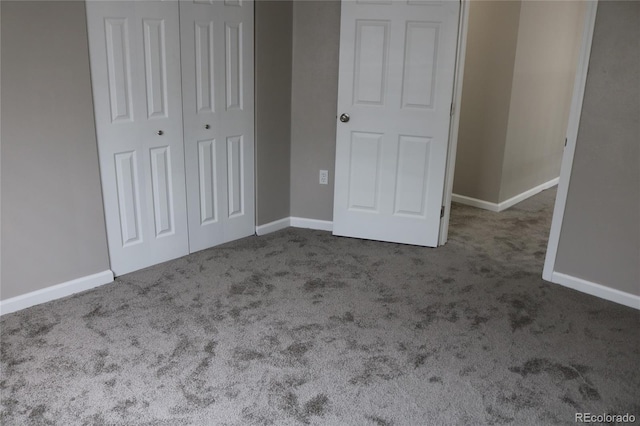 unfurnished bedroom with a closet and carpet flooring