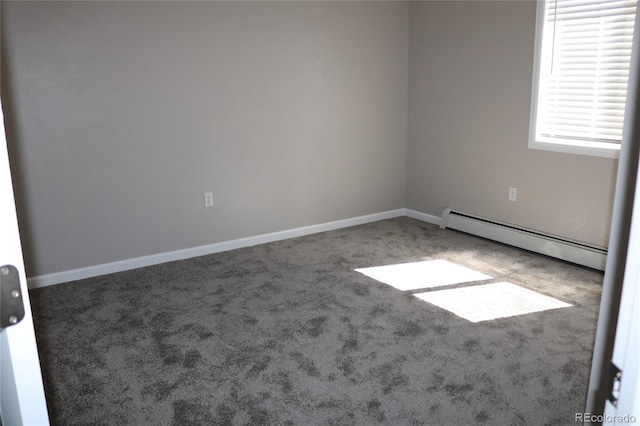 empty room featuring a baseboard radiator and carpet