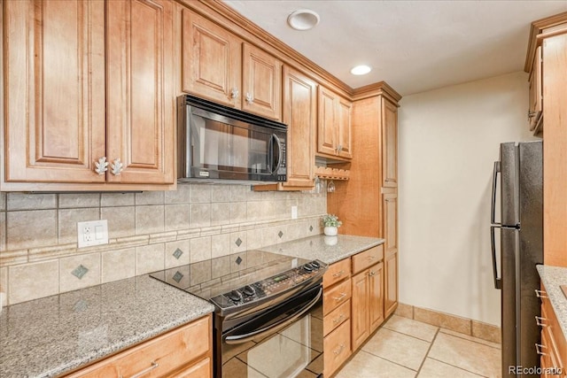 189 Ten Mile Cir Unit 551, Frisco, CO 80443 - kitchen with black appliances, light tile patterned floors, tasteful backsplash, light stone countertops, and recessed lighting