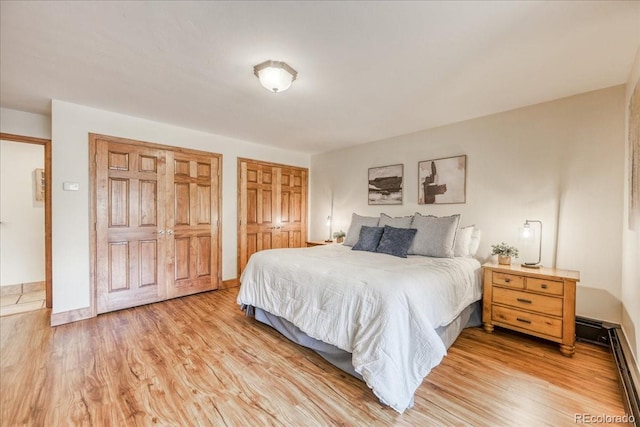 189 Ten Mile Cir Unit 551, Frisco, CO 80443 - bedroom with two closets, light wood finished floors, and baseboard heating