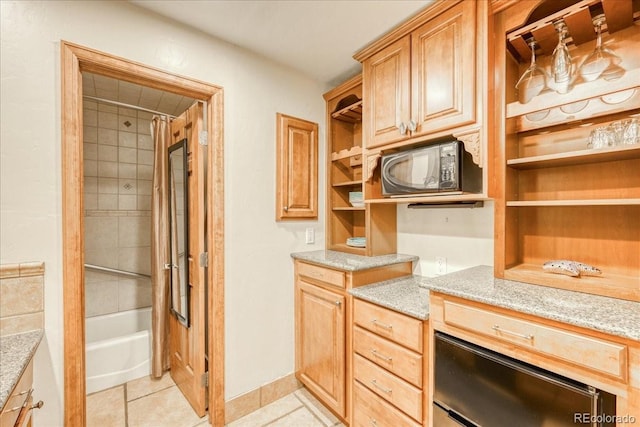 189 Ten Mile Cir Unit 551, Frisco, CO 80443 - kitchen with open shelves, black microwave, light tile patterned floors, and light stone counters