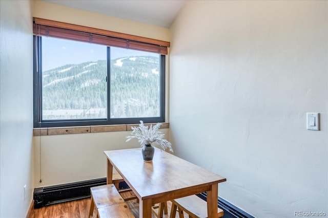 189 Ten Mile Cir Unit 551, Frisco, CO 80443 - dining space featuring a baseboard radiator and wood finished floors