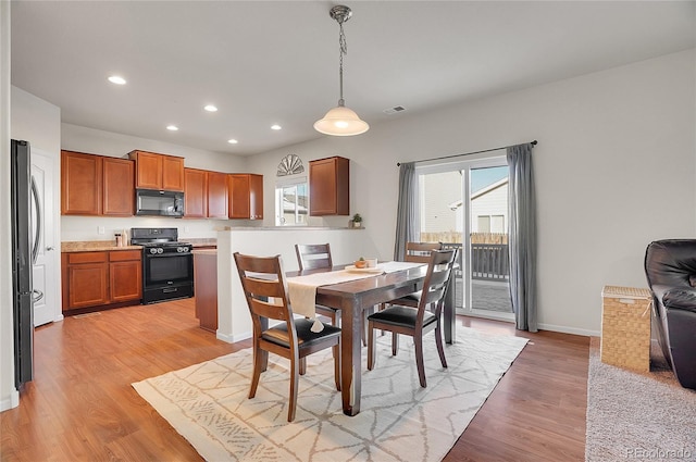 dining area with light hardwood / wood-style floors