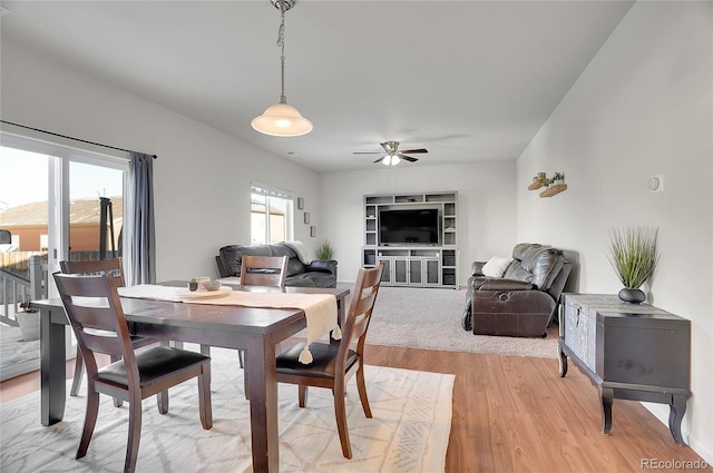 dining area featuring ceiling fan and light wood-type flooring