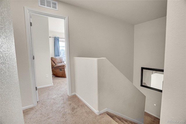 hallway featuring light carpet