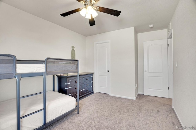 unfurnished bedroom with light carpet and ceiling fan