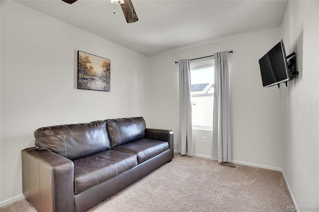 carpeted living room with ceiling fan