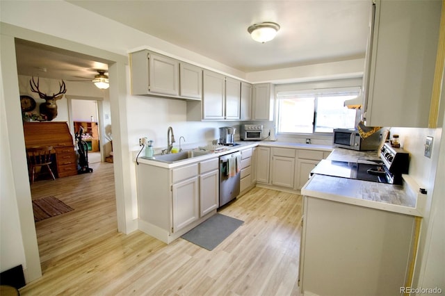 7013 County Road 69, Keenesburg, CO 80643 - kitchen featuring a sink, stainless steel appliances, light wood-type flooring, and ceiling fan