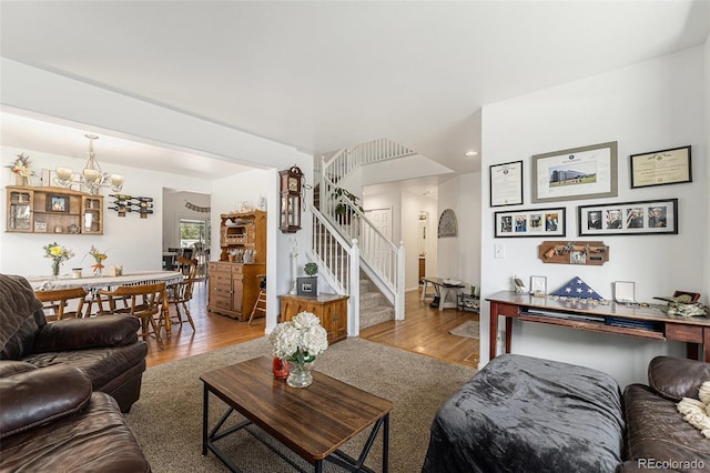 17464 Crestview Ct, Monument, CO 80132 - living room featuring wood finished floors, stairway, and a chandelier