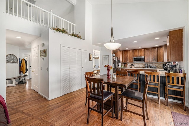 17464 Crestview Ct, Monument, CO 80132 - dining space with a high ceiling and light wood finished floors