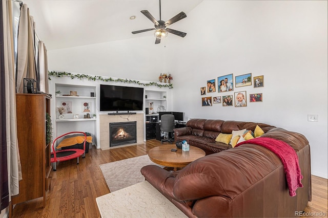 17464 Crestview Ct, Monument, CO 80132 - living room featuring ceiling fan, a tile fireplace, wood finished floors, and high vaulted ceiling