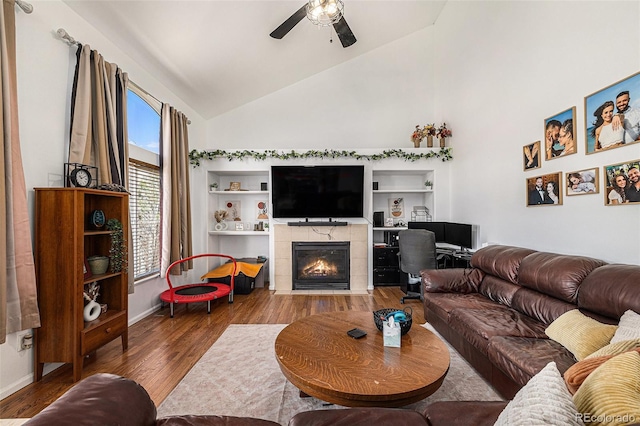 17464 Crestview Ct, Monument, CO 80132 - living area featuring ceiling fan, a desk, wood finished floors, a fireplace, and high vaulted ceiling