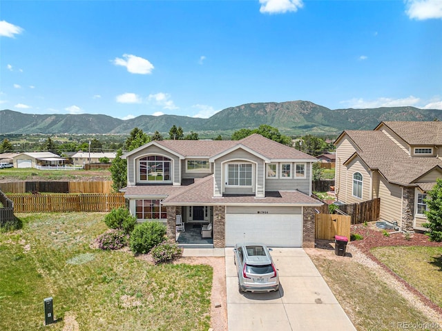 17464 Crestview Ct, Monument, CO 80132 - traditional-style home featuring a mountain view, concrete driveway, brick siding, and a garage