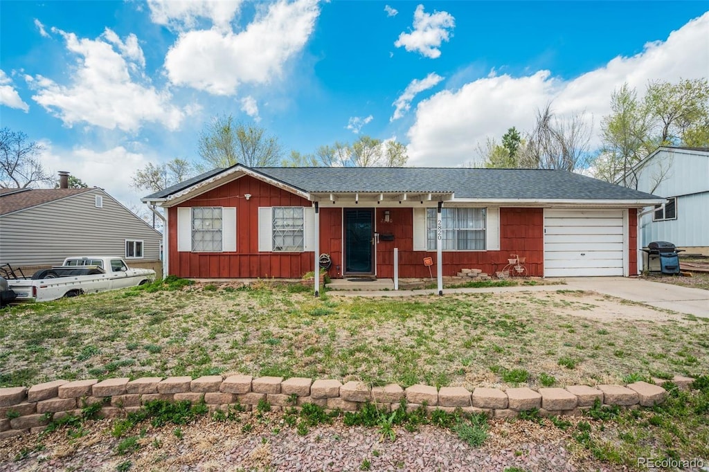 single story home with a garage, board and batten siding, and driveway
