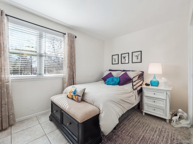 bedroom featuring baseboards and light tile patterned floors